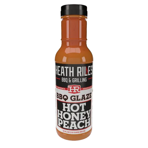 A full bottle of Heath Riles Hot Honey Peach BBQ Glaze.