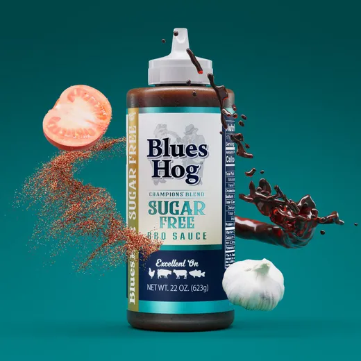 A stylized bottle of Blues Hog Sugar Free BBQ Sauce with floating ingredients.