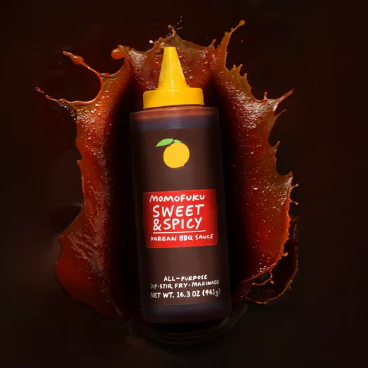 Another product shot of the sauce bottle with sauce splash.