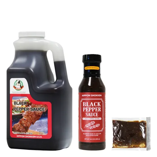 A display featuring a large jug, a retail bottle, and a small packet of Nippon Shokken Black Pepper Sauce.