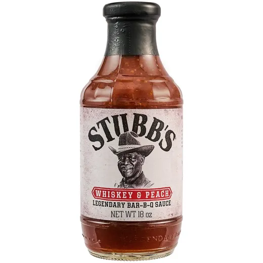 A full bottle of Stubbs Whiskey & Peach BBQ sauce on a white background.