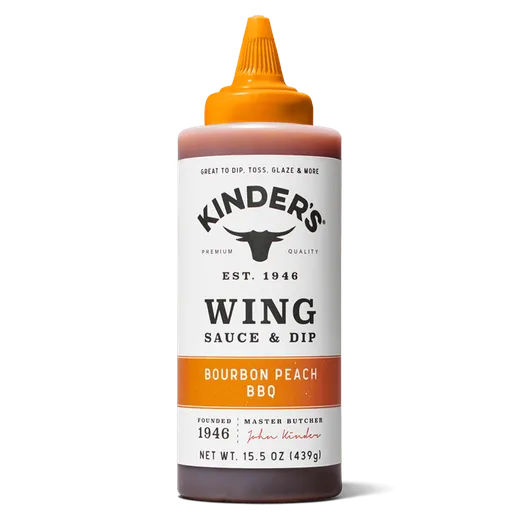 A bottle of Kinder's Bourbon Peach BBQ wing sauce and dip against a white background.