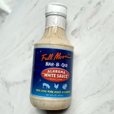 A front-facing view of the Full Moon Bar-B-Que sauce bottle.