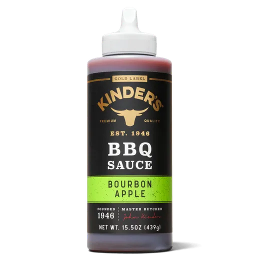 A black bottle of Kinder's Bourbon Apple BBQ sauce against a white background.